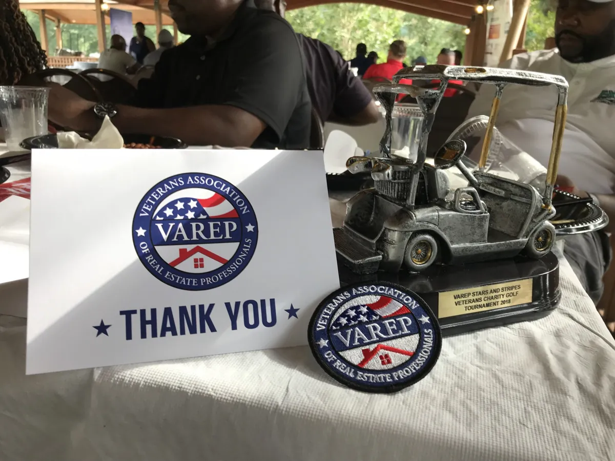 A VAREP thank-you card and award on a table