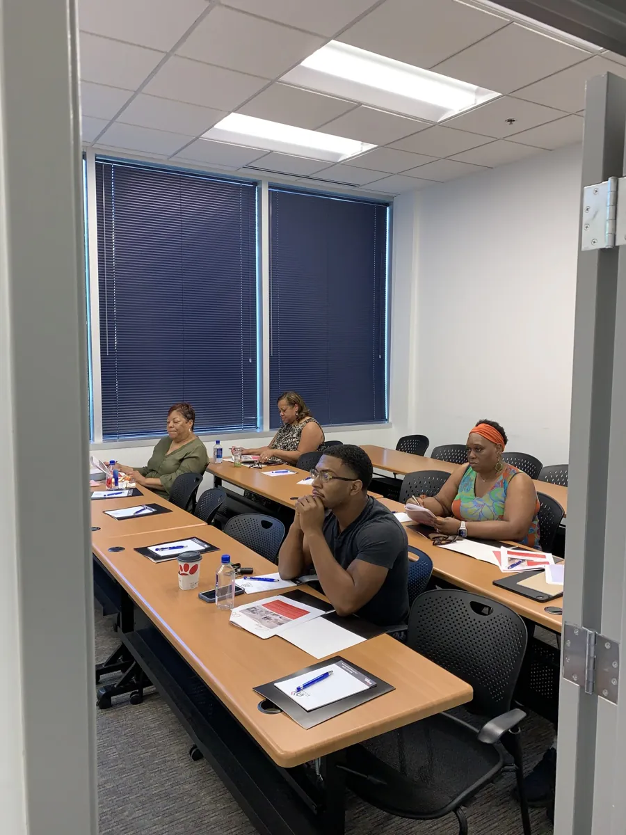 Attendees taking notes in a classroom workshop